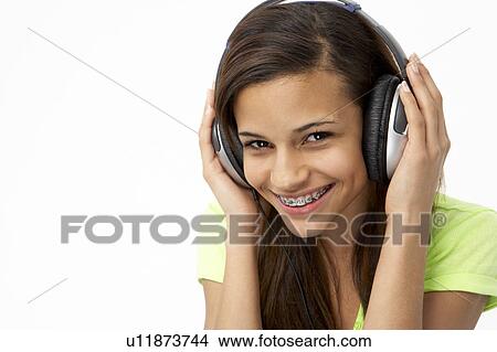 Picture - Portrait of Smiling Teenage Girl Listening to Music. Fotosearch