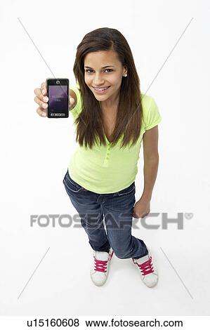 Portrait of Smiling Teenage Girl Holding Mobile Phone View Large Photo Image Stock Photo - Portrait of Smiling Teenage Girl Holding Mobile Phone. Fotosearch