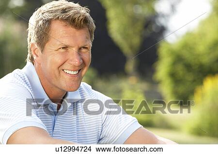 Portrait of young man relaxing in countryside View Large Photo Image Picture - Portrait of young man relaxing in countryside. Fotosearch