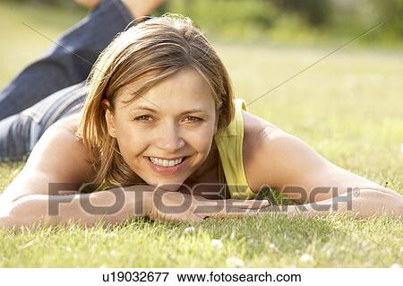 Portrait of young woman relaxing in countryside View Large Photo Image Stock Photo - Portrait of young woman relaxing in countryside. Fotosearch