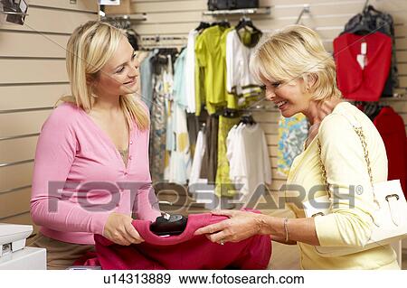 Sales assistant with customer in clothing store View Large Photo Image Stock Photo - Sales assistant with customer in clothing store. Fotosearch