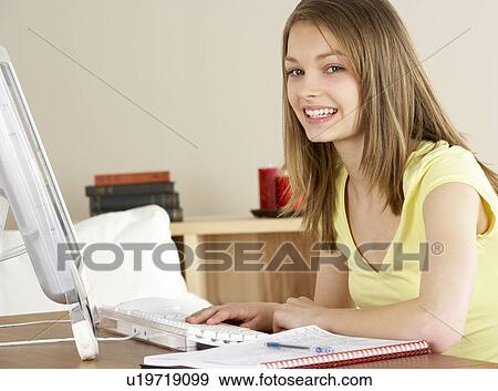 Stock Photo - Smiling Teenage Girl Studying at Home. Fotosearch