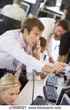Stock Image - Stock Trader On The Phone. Fotosearch