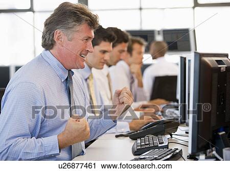 Stock Image - Stock Traders At Work. Fotosearch