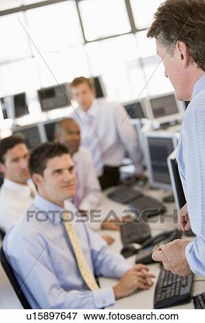 Stock Photo - Stock Traders At Work. Fotosearch