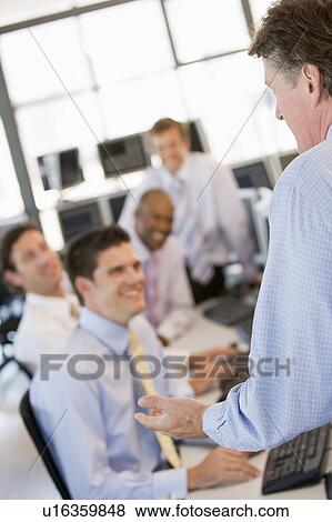 Stock Photo - Stock Traders At Work. Fotosearch