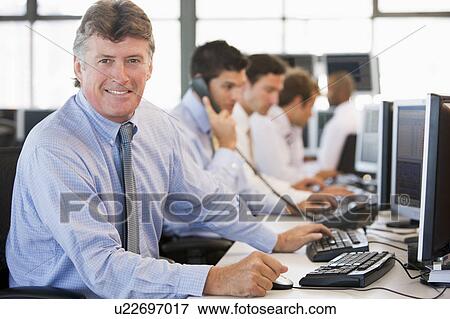 Stock Photo - Stock Traders At Work. Fotosearch