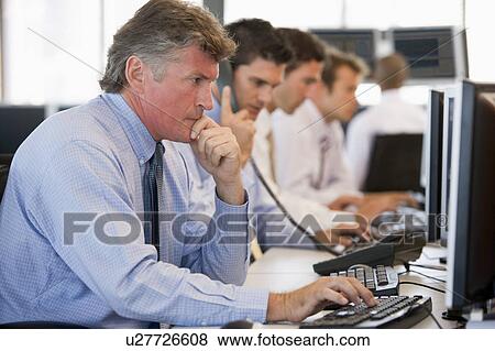 Stock Photo - Stock Traders At Work. Fotosearch