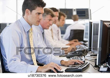Stock Photograph - Stock Traders At Work. Fotosearch