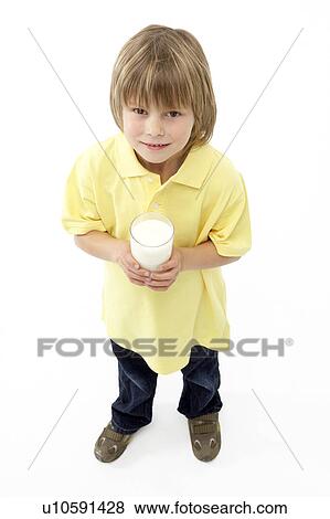 Stock Photo - Studio Portrait of Smiling Boy Holding Glass of Milk. Fotosearch