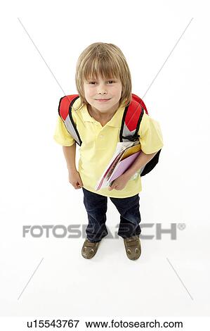 Stock Photo - Studio Portrait of Smiling Boy Holding Books. Fotosearch