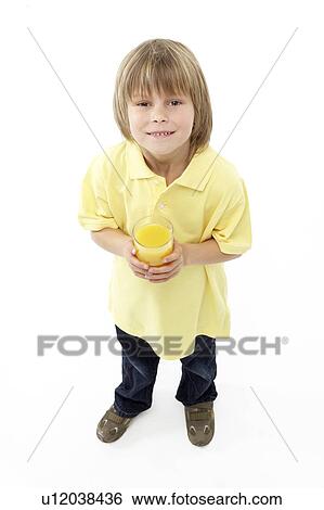 Stock Photograph - Studio Portrait of Smiling Boy Holding Glass of Fruit Juice. Fotosearch