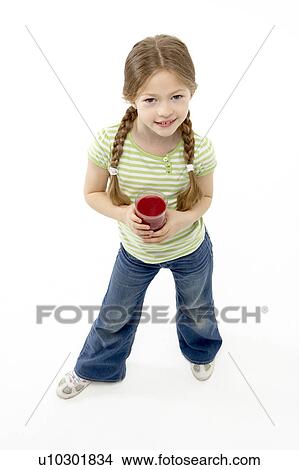 Studio Portrait of Smiling Girl Holding Glass of Juice View Large Photo Image Picture - Studio Portrait of Smiling Girl Holding Glass of Juice. Fotosearch