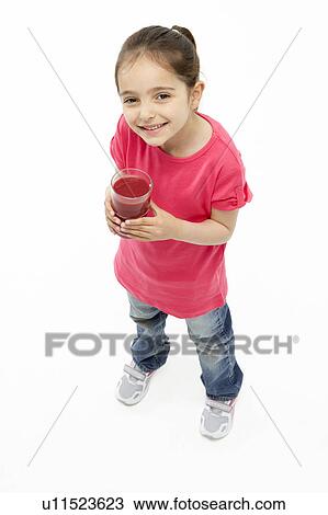 Studio Portrait of Smiling Girl Holding Glass of Juice View Large Photo Image Stock Image - Studio Portrait of Smiling Girl Holding Glass of Juice. Fotosearch