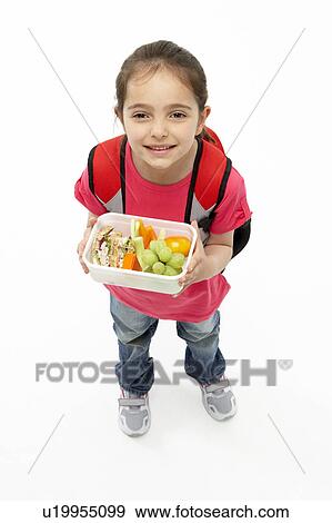 Studio Portrait of Smiling Girl Holding Lunchbox View Large Photo Image Stock Photo - Studio Portrait of Smiling Girl Holding Lunchbox. Fotosearch