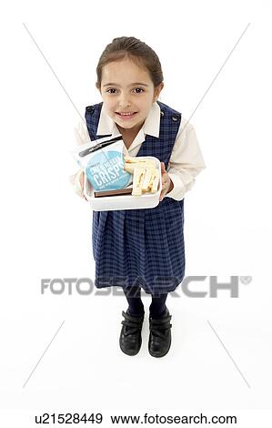 Stock Photo - Studio Portrait of Smiling Girl Holding Lunchbox. Fotosearch