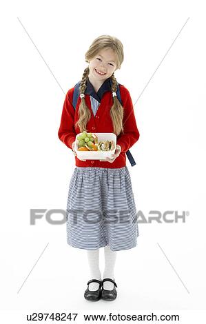 Stock Photo - Studio Portrait of Smiling Girl Holding Lunchbox. Fotosearch