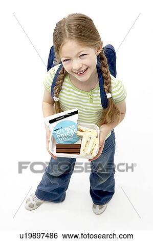 Stock Photograph - Studio Portrait of Smiling Girl Holding Lunchbox. Fotosearch