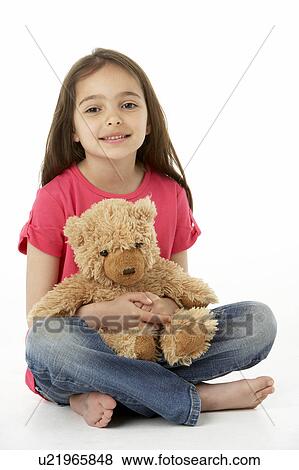Stock Photo - Studio Portrait Of Smiling Girl with Teddy Bear. Fotosearch