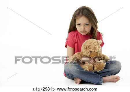 Stock Photography - Studio Portrait Of Smiling Girl with Teddy Bear. Fotosearch