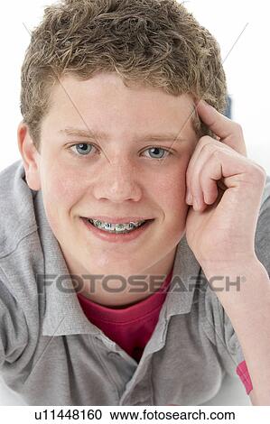 Stock Image - Studio Portrait of Smiling Teenage Boy. Fotosearch