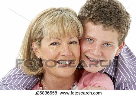Stock Photo - Studio Portrait of Smiling Teenage Boy with Mum. Fotosearch