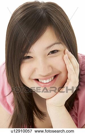 Stock Photo - Studio Portrait of Smiling Teenage Girl. Fotosearch