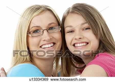 Studio Portrait of Smiling Teenage Girl with older Sister View Large Photo Image Stock Photo - Studio Portrait of Smiling Teenage Girl with older Sister. Fotosearch