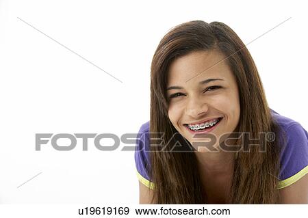 Stock Photo - Studio Portrait of Smiling Teenage Girl. Fotosearch