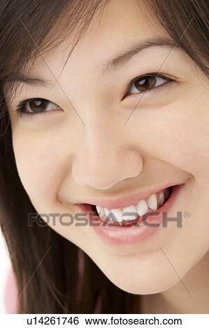 Stock Photograph - Studio Portrait of Smiling Teenage Girl. Fotosearch