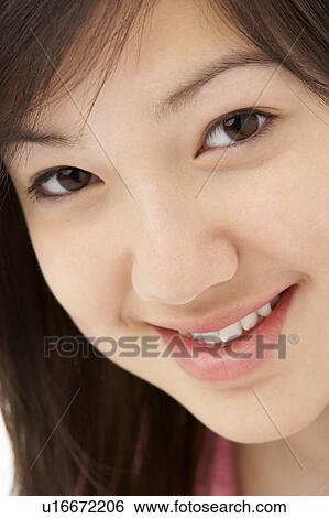 Stock Photograph - Studio Portrait of Smiling Teenage Girl. Fotosearch