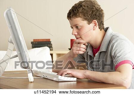 Picture - Teenage Boy in Thought Studying at Home. Fotosearch