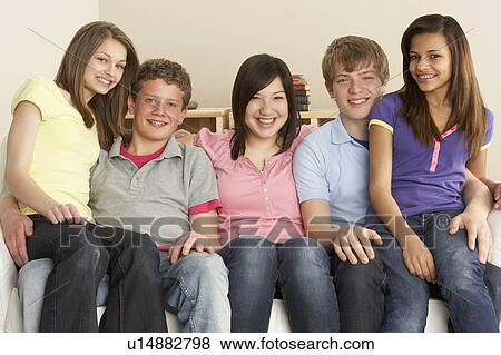 Stock Photo - Teenage Friends Relaxing at Home. Fotosearch
