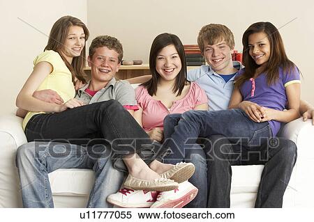 Stock Photography - Teenage Friends Relaxing at Home. Fotosearch