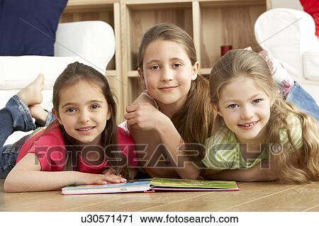 Three Young Girls Reading Book at Home View Large Photo Image Stock Image - Three Young Girls Reading Book at Home. Fotosearch
