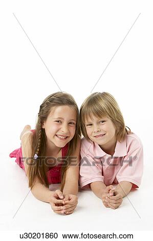 Two Children Laying on Stomach in Studio View Large Photo Image Stock Image - Two Children Laying on Stomach in Studio. Fotosearch