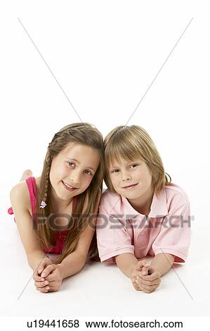 Two Children Laying on Stomach in Studio View Large Photo Image Stock Photo - Two Children Laying on Stomach in Studio. Fotosearch