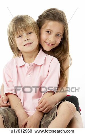 Two Children Sitting with each other in Studio View Large Photo Image Stock Photo - Two Children Sitting with each other in Studio. Fotosearch