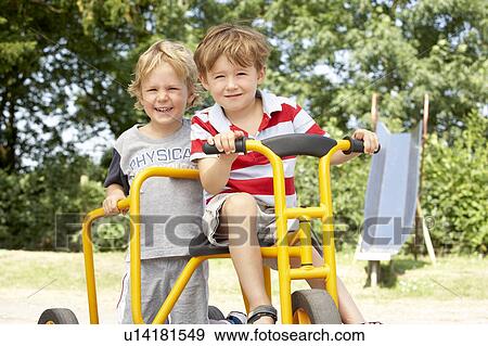 Two Young Boys Playing on Bike View Large Photo Image Stock Photo - Two Young Boys Playing on Bike. Fotosearch