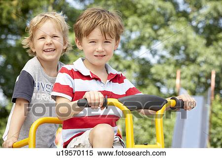 Two Young Boys Playing on Bike View Large Photo Image Stock Photography - Two Young Boys Playing on Bike. Fotosearch