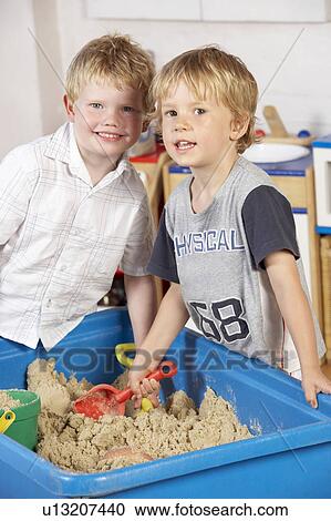 Two Young Boys Playing Together in Sandpit View Large Photo Image Stock Image - Two Young Boys Playing Together in Sandpit . Fotosearch
