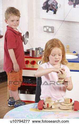 Stock Photo - Two Young Children Playing Together at Montessori/Pre-School. Fotosearch