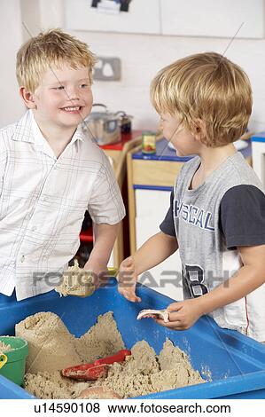 Two Young Children Playing Together at Montessori/Pre-School View Large Photo Image Stock Photo - Two Young Children Playing Together at Montessori/Pre-School. Fotosearch