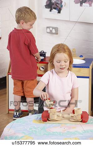 Stock Photography - Two Young Children Playing Together at Montessori/Pre-School. Fotosearch
