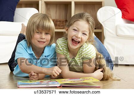 Two Young Children Reading Book at Home View Large Photo Image Stock Image - Two Young Children Reading Book at Home. Fotosearch