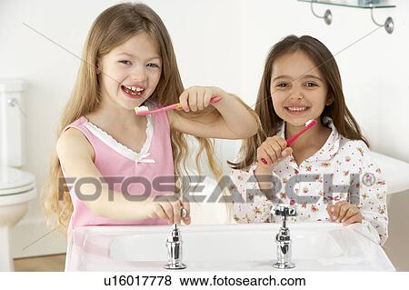 Two Young Girls Brushing Teeth at Sink View Large Photo Image Stock Photo - Two Young Girls Brushing Teeth at Sink. Fotosearch