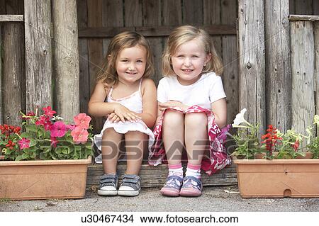Two Young Girls Playing in Wooden House View Large Photo Image Picture - Two Young Girls Playing in Wooden House. Fotosearch