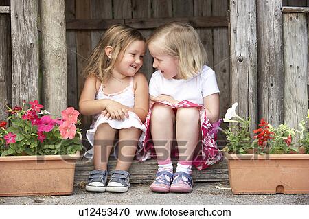 Two Young Girls Playing in Wooden House View Large Photo Image Stock Image - Two Young Girls Playing in Wooden House. Fotosearch