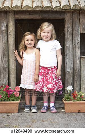 Two Young Girls Playing in Wooden House View Large Photo Image Stock Photo - Two Young Girls Playing in Wooden House. Fotosearch