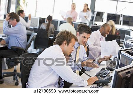 Stock Image - View Of Busy Stock Traders Office. Fotosearch